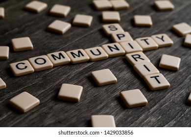 Family/community Spirit Affirmation Spelt Out With Tiles On A Timber Surface