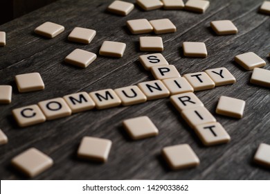 Family/community Spirit Affirmation Spelt Out With Tiles On A Timber Surface