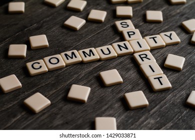 Family/community Spirit Affirmation Spelt Out With Tiles On A Timber Surface