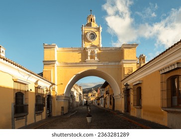 The famous arch of Santa Catalina in downtown Antigua, Guatemala and a view of the Volcano de Agua behind