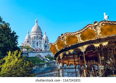 Famous Basilica Of Sacre-Coeur In Montmartre, Paris At Sunset With Carousel Horse Ride, No People