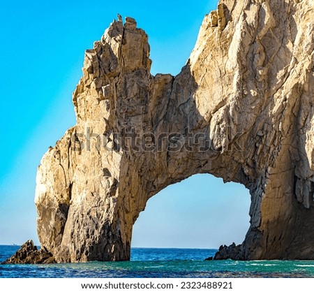 The famous and beautiful arch of Cabo San Lucas in the Gulf of California that joins the sea of cuts with the Pacific Ocean at the end of the land, in Baja California Sur. Beach concept in Mexico.