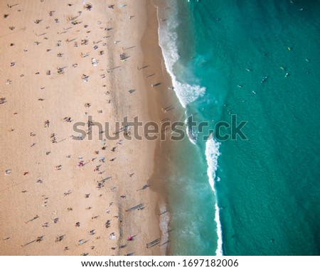 Similar – Luftaufnahme von fliegenden Drohnen von Menschen, die sich am Algarve Beach in Portugal entspannen.