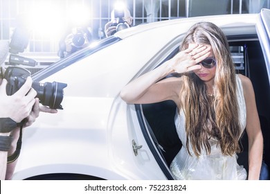 famous celebrity getting out of a limousine in front of a red carpet event, with flashing paparazzi 