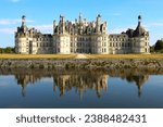 Famous Chateau de Chambord with reflection on the decorative Cosson moat