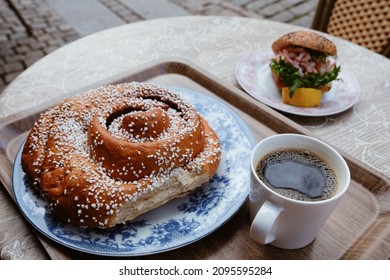 Famous cinnamon bun big as a head in popular café in the streets of Gothenburg, Sweden.