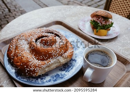 Famous cinnamon bun big as a head in popular café in the streets of Gothenburg, Sweden. [[stock_photo]] © 
