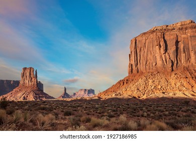 The famous cliffs Mittens in Monument Valley. The rocks - outcrops made of red sandstone. Bright multi-color sunset on the red stone valley. The concept of active, environmental and photo tourism - Powered by Shutterstock