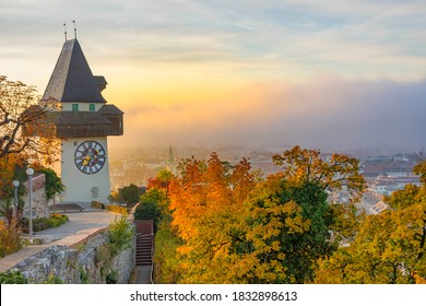 The famous clock tower on Schlossberg hill, in Graz, Styria region, Austria, at sunrise. Beautiful foggy morning over the city of Graz, in autumn - Powered by Shutterstock