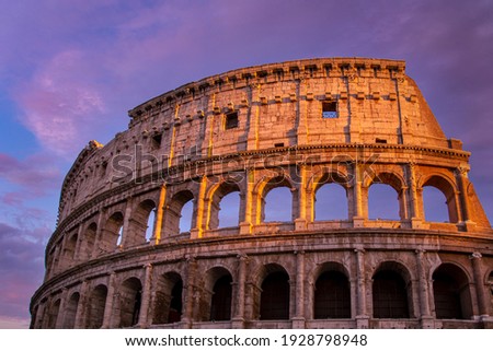 Famous Coliseum (Colosseum) of Rome at early sunset.