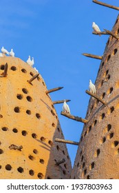 Famous Earthen Pigeon Towers With White Pigeon Flying Away In Katara Cultural Village Of Doha, Qatar