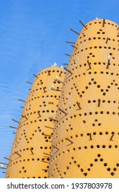 Famous Earthen Pigeon Towers With White Pigeon Flying Away In Katara Cultural Village Of Doha, Qatar