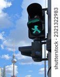 The famous East Berlin pedestrian traffic light on green, in the background the television tower in Mitt