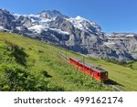 Famous electric red tourist train coming down from the Jungfraujoch station (top of Europe) in Kleine Scheidegg, Bernese Oberland, Switzerland, Europe. Glacier Express.