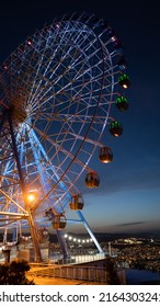 Famous ferris wheel in Mtatsminda amusement park in Tbilisi, Georgia. Illuminated giant wheel at night. Entertainment concept - Shutterstock ID 2164303241