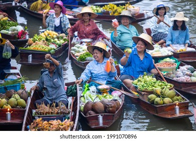Famous floating market in Thailand, Damnoen Saduak floating market, Farmer go to sell organic products, fruits, vegetables and Thai cuisine, Tourists visiting by boat, Ratchaburi, Thailand.