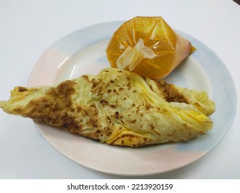 The Famous Food In Malaysia Is Known As Roti Canai, Roti Canai In A Plate Isolated On White Background