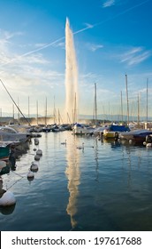 Famous fountain reflection  on Geneva lake during sunset.