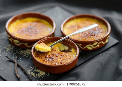 famous french dessert speciality , the creme brulee on a black slate - Shutterstock ID 1790961875