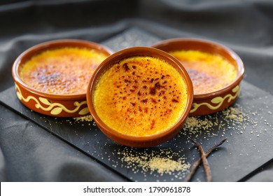 famous french dessert speciality , the creme brulee on a black slate - Shutterstock ID 1790961878