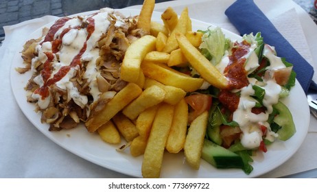 Famous German Doner Kebab With French Fries And Salad On White Plate