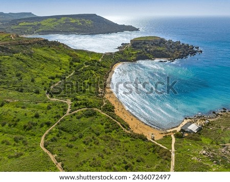 Famous Ghain Tuffieha bay and beach. Spring, green countryside. Malta island