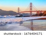 Famous Golden Gate Bridge view from Baker Beach at sunset in San Francisco, California