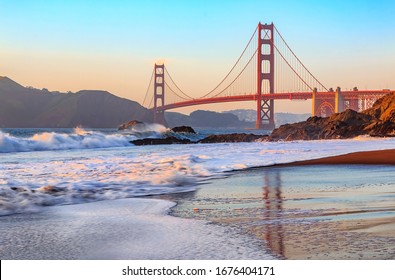 Famous Golden Gate Bridge view from Baker Beach at sunset in San Francisco, California