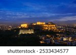 Famous greek tourist landmark - the iconic Parthenon Temple at the Acropolis of Athens as seen from Philopappos Hill in the evening blue hour, Athens, Greece