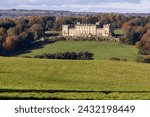 The famous Harewood House in Leeds West Yorkshire in the UK taken from across a large field in the British country side in the Autumn time 