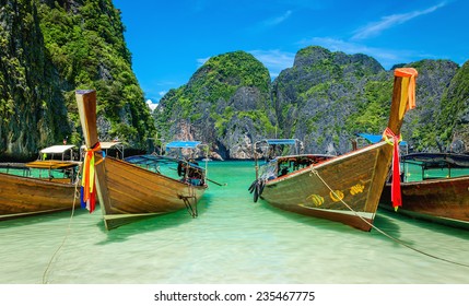 The famous heavenly beach Maya Bay on Phi Phi Islands with colorful longtail boats and limestone hills in the background, Thailand