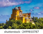 Famous historic Pena palace part of cultural site of Sintra against sunset sky in Portugal. Panoramic View Of Pena Palace, Sintra, Portugal. Pena National Palace at sunset, Sintra, Portugal. 