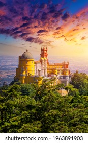 Famous historic Pena palace part of cultural site of Sintra against sunset sky in Portugal. Panoramic View Of Pena Palace, Sintra, Portugal. Pena National Palace at sunset, Sintra, Portugal. 