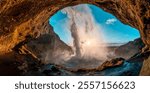 Famous icelandic waterfall Seljalandsfoss during golden hour with mist 