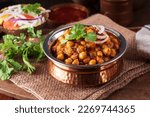 Famous Indian dish chana masala in traditional bowl