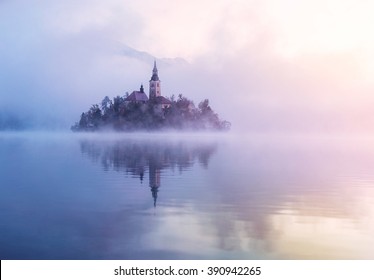 Famous island with old church in the city of Bled. Misty morning with gorgeous lights and colors. Alps mountains in the background. Slovenia, Europe - Powered by Shutterstock