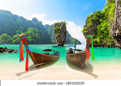 Famous James Bond Island Near Phuket In Thailand. Travel Photo Of James Bond Island With Thai Traditional Wooden Longtail Boat And Beautiful Sand Beach In Phang Nga Bay, Thailand.