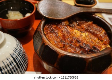 Famous Japanese food, Hitsumabashi eel, Famous dish in Nagoya Japan. Unadon or Grill eel on rice served in wooden bowl with rice ladle for divide the bowl's contents into four servings.