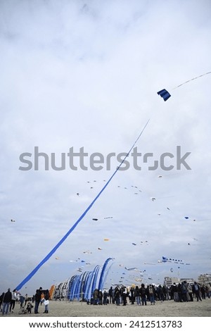 Similar – a colorful garland blows in the wind on the north sea