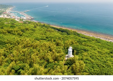 A famous lighthouse in South Taiwan, Xiao Liuqiu in Pingtung, Taiwan. Aerial landscape of sunny day, clear ocean, beach, shore, transparent water, and white lighthouse. It is nearby Kaohsiung.