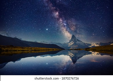 Famous Matterhorn spire under the starry sky. Location Stellisee lake, Cervino peak, Swiss alp, Switzerland, Europe. Photo of popular touristic place. Long exposure shot. Discover the beauty of earth. - Powered by Shutterstock