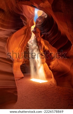 Famous midday sun ray in a slot canyon Antelope. The Navajo reservation, Arizona, USA - Travel concept.