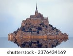 famous monastery of Mont Saint Michel with the Abbey church built above the hill during high tide in northern France in the Normandy region