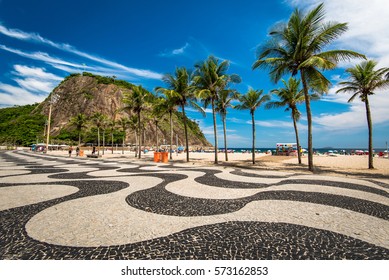 Famous Mosaic of Sidewalk and Palm Trees in Leme and Copacabana Beach in Rio de Janeiro, Brazil