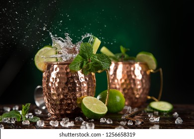 Famous Moscow mule alcoholic cocktail in copper mugs, close-up.