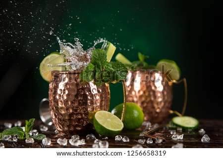 Famous Moscow mule alcoholic cocktail in copper mugs, close-up.