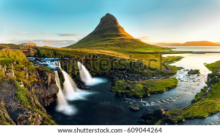 The famous mountain Kirkjufell and its waterfalls are pictured in a panoramic long exposure during a sunset on the Snaefellsness Peninsula near the North East Coast of Iceland