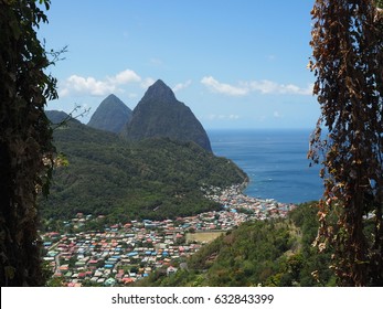 The Famous Mountainous View Of The Pitons In Soufrière, St. Lucia Looking From Viewpoint Over The Island Village Full Of Colorful Rooftops And Ocean View