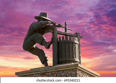 Famous Napa Valley Grape Crusher Statue, Monument and Wine colored Sunset Sky