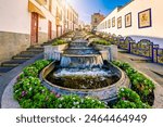 Famous Paseo de Canarias street on Firgas, Gran Canaria, Canary Islands, Spain. Fountain of natural mineral water in Firgas, Gran Canaria. Village Firgas at Gran Canaria, Paseo de Canarias